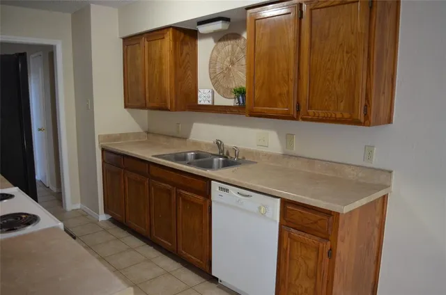 a kitchen with a sink cabinets and a wooden floor