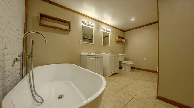 a bathroom with a tub and toilet
