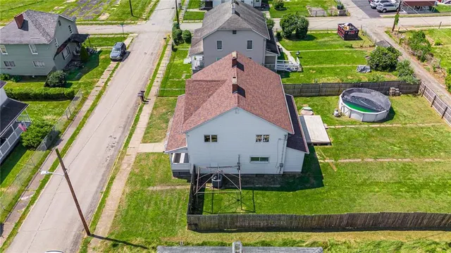 a aerial view of a house with a yard