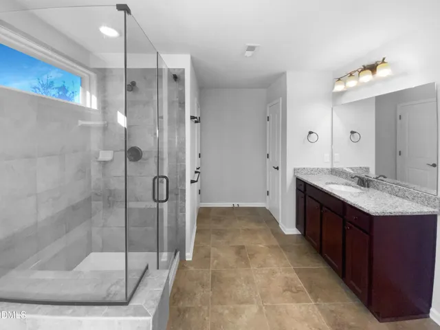 a bathroom with a granite countertop sink mirror and double