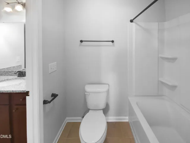 a bathroom with a toilet and a bathtub