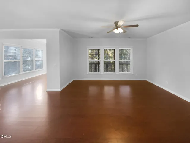 a view of room with window and wooden floor