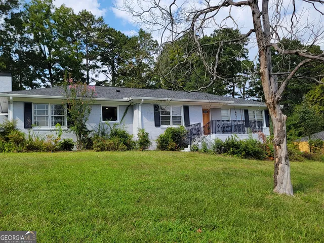 a front view of house with yard and green space