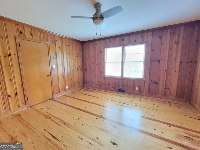 a view of a livingroom with wooden floor and window