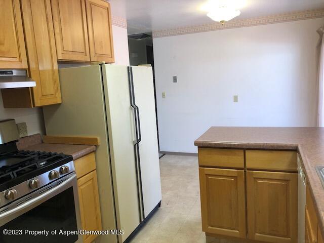 558 Steele Street Craig, CO 81625 - Photo 29 of 52 a kitchen with a stove and a refrigerator
