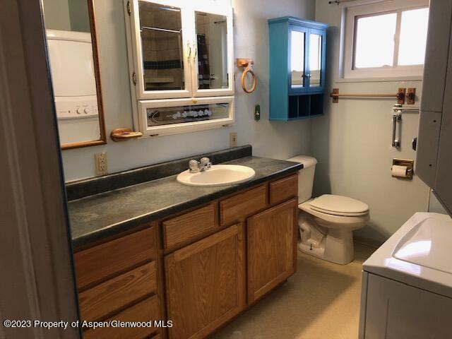 558 Steele Street Craig, CO 81625 - Photo 32 of 52 a bathroom with a granite countertop sink toilet and mirror