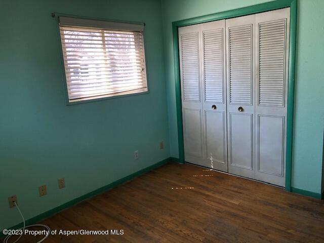 558 Steele Street Craig, CO 81625 - Photo 37 of 52 a view of an empty room with wooden floor and a window