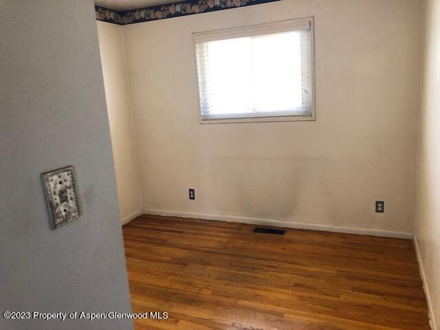 558 Steele Street Craig, CO 81625 - Photo 38 of 52 a view of room with window and wooden floor