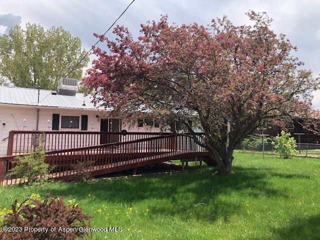 558 Steele Street Craig, CO 81625 - Photo 4 of 52 a view of a yard in front of a house with a large tree