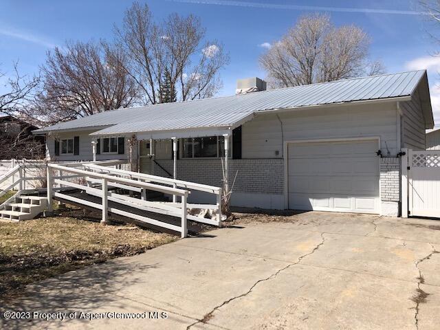 558 Steele Street Craig, CO 81625 - Photo 8 of 52 a view of a house with a yard and garage