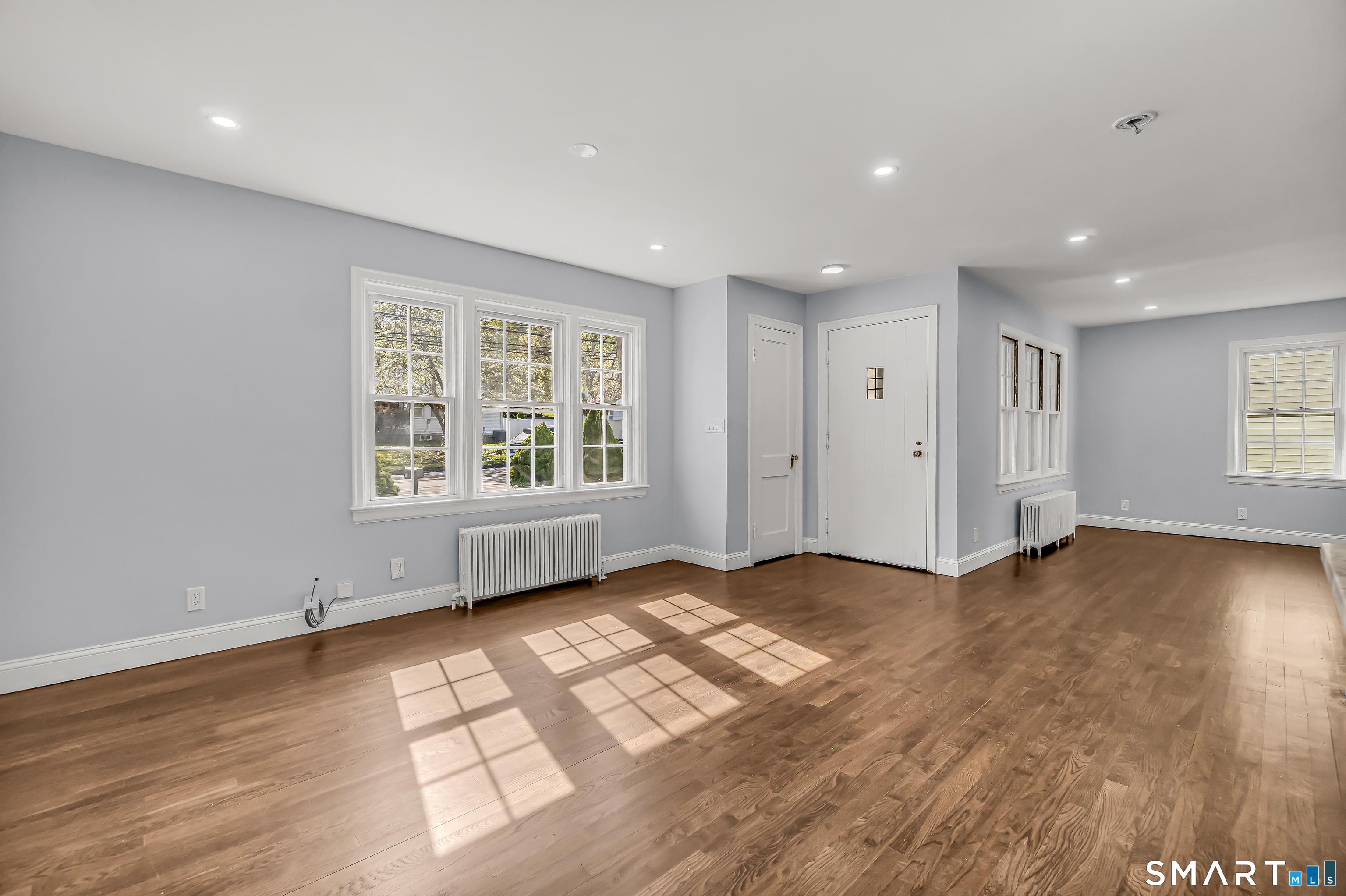 1770 Stratfield Road Fairfield, CT 06825 - Photo 12 of 40 a view of an empty room with a window and wooden floor