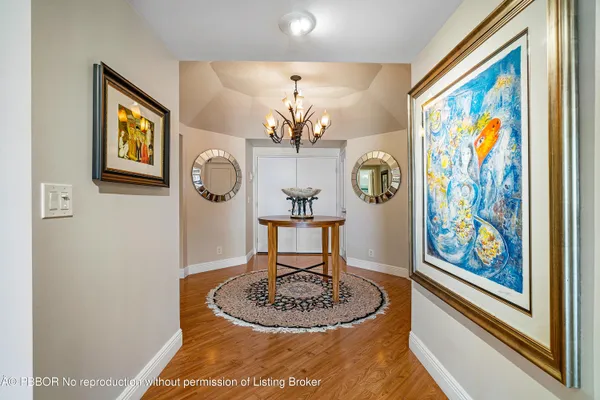 a dining room with furniture and a chandelier