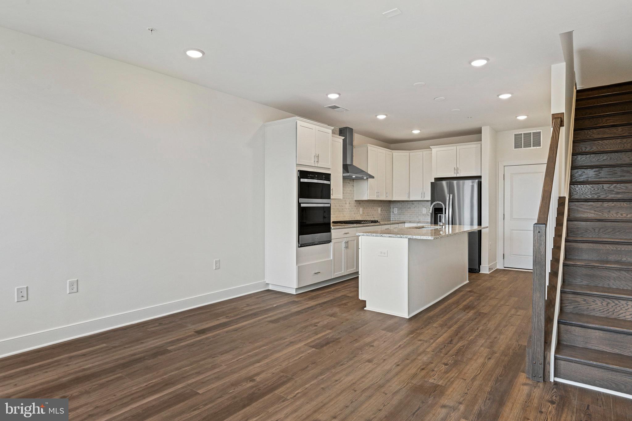a view of kitchen with wooden floor and electronic appliances