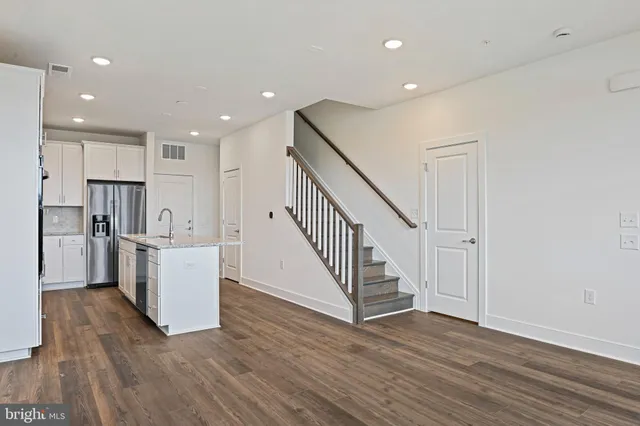 a view of kitchen with wooden floor and electronic appliances