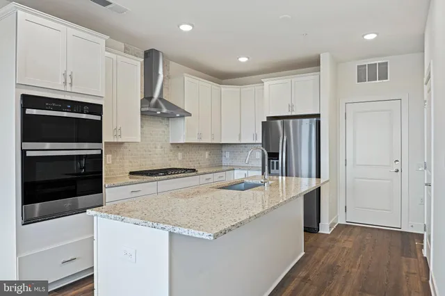 a kitchen with a sink a microwave a stove and refrigerator