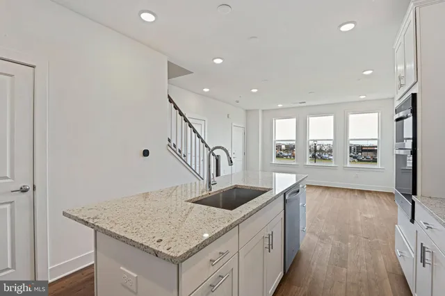 a kitchen with granite countertop a stove and a sink