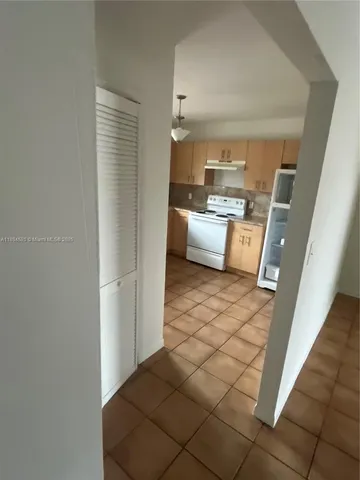 a room with a sink and a view of living room