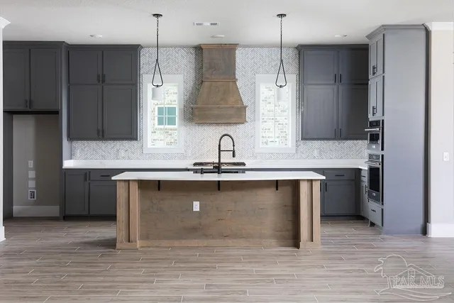 a kitchen with a sink cabinets and window