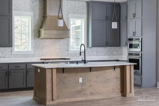 a kitchen with a sink cabinets and window