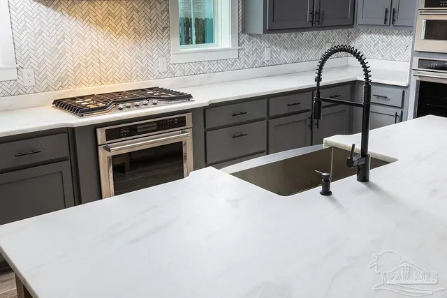 a kitchen with a stove and a sink