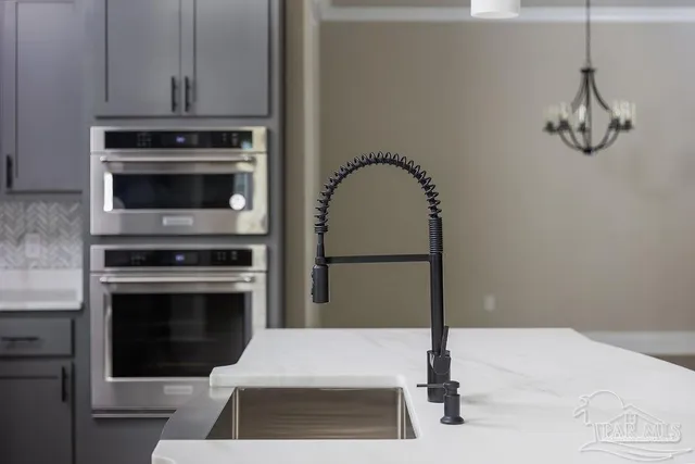 a kitchen with a stove and white cabinets