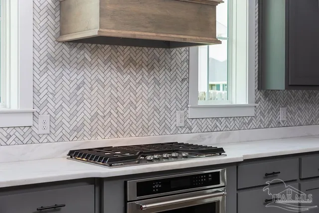 a stove top oven sitting inside of a kitchen
