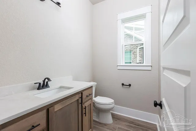 a bathroom with a sink toilet and a window