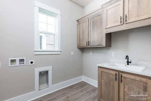 a bathroom with a sink cabinets and a window