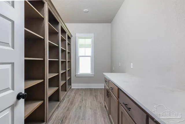 a kitchen with a sink and wooden floor