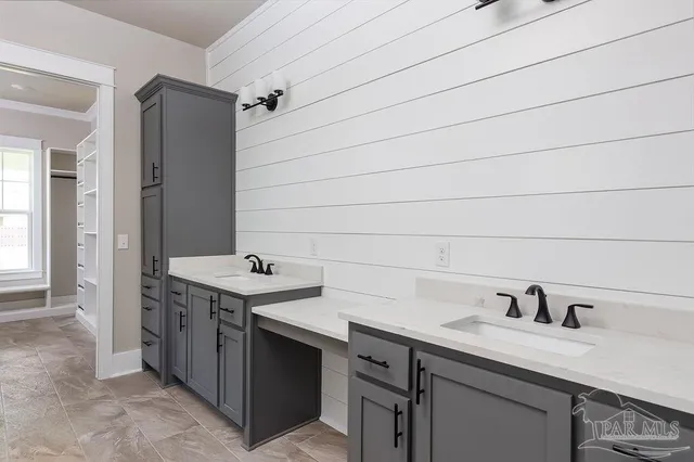 a utility room with a sink and cabinets