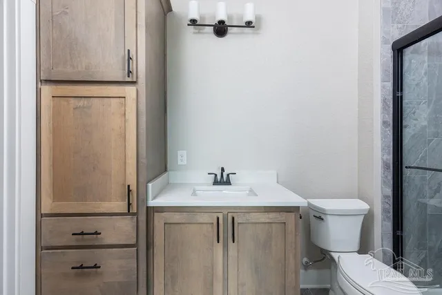 a bathroom with a sink toilet and mirror