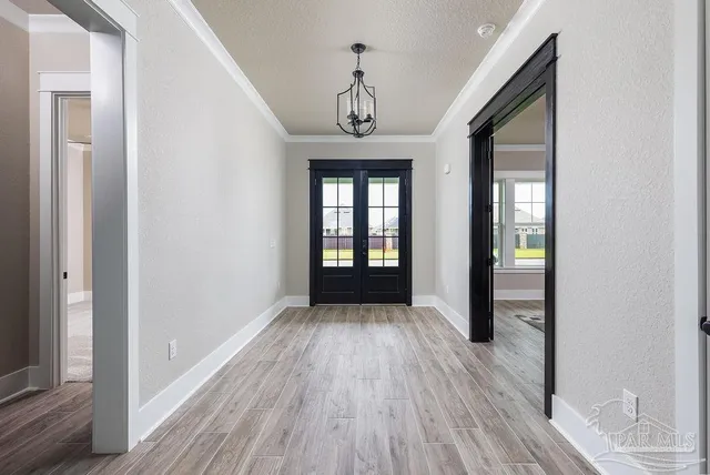a view of a hallway with wooden floor and a window