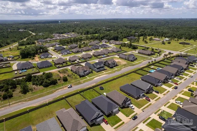 an aerial view of residential houses with outdoor space