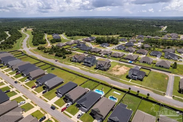 an aerial view of residential houses with outdoor space