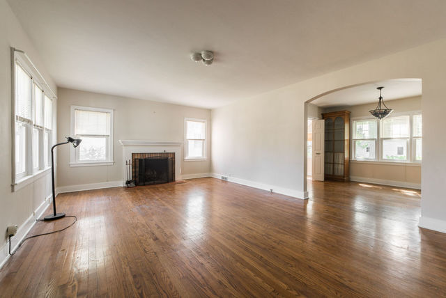 645 Normal Road DeKalb, IL 60115 - Photo 2 of 24 a view of empty room with a fireplace and wooden floor