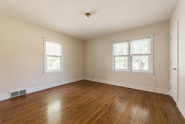 645 Normal Road DeKalb, IL 60115 - Photo 11 of 24 an empty room with wooden floor and windows