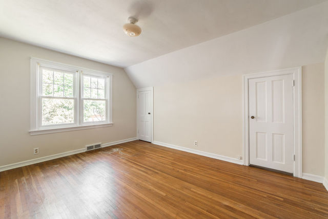 645 Normal Road DeKalb, IL 60115 - Photo 12 of 24 an empty room with wooden floor and windows