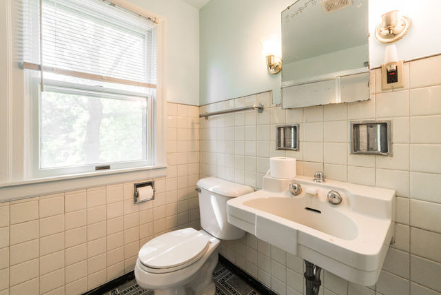645 Normal Road DeKalb, IL 60115 - Photo 14 of 24 a bathroom with a sink a toilet and a mirror