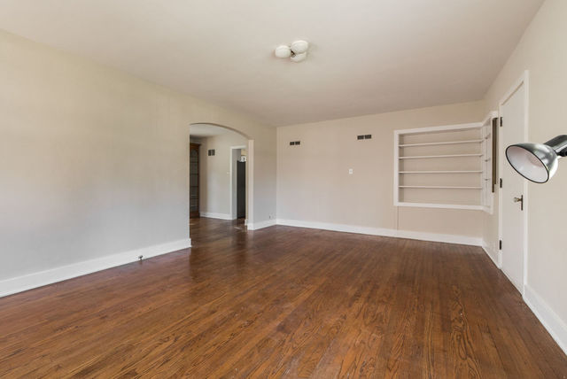 645 Normal Road DeKalb, IL 60115 - Photo 3 of 24 a view of an empty room with wooden floor and a window