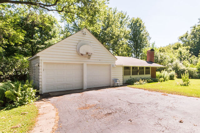 645 Normal Road DeKalb, IL 60115 - Photo 21 of 24 a front view of a house with a yard and garage