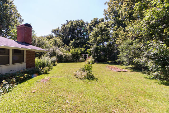 645 Normal Road DeKalb, IL 60115 - Photo 22 of 24 a view of a swimming pool with some potted plants and large tree