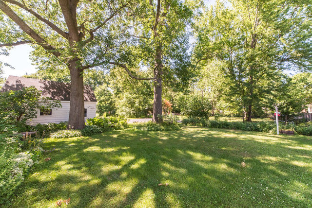 645 Normal Road DeKalb, IL 60115 - Photo 23 of 24 a backyard of a house with lots of green space and fountain