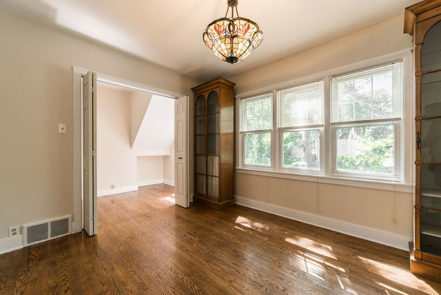 645 Normal Road DeKalb, IL 60115 - Photo 4 of 24 an empty room with wooden floor and windows