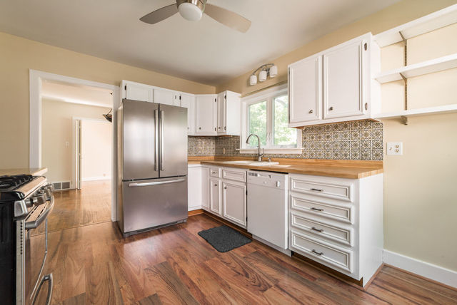 645 Normal Road DeKalb, IL 60115 - Photo 8 of 24 a kitchen with granite countertop white cabinets and stainless steel appliances