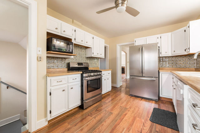 645 Normal Road DeKalb, IL 60115 - Photo 9 of 24 a kitchen with stainless steel appliances a refrigerator stove and microwave
