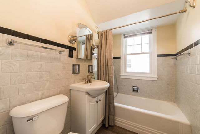 645 Normal Road DeKalb, IL 60115 - Photo 10 of 24 a bathroom with a sink a toilet and shower