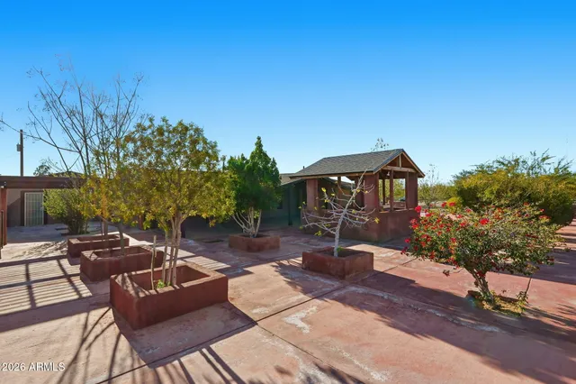 a backyard of a house with table and chairs