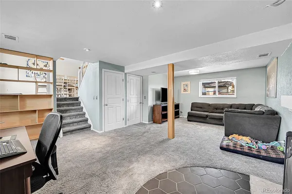 a view of a livingroom with workspace and a window