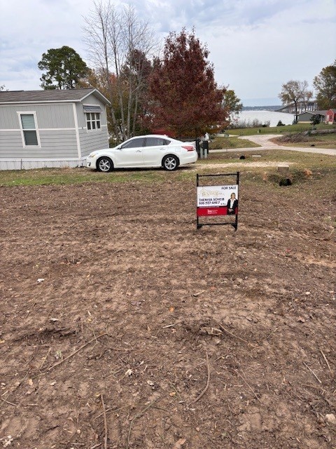 Lot 251 Canal Dr Point Point Blank, TX 77364 - Photo 6 of 9 Close up of lot. You can see Lake Livingston in the background just at the end of the street.
