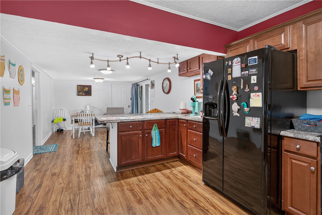 230 Dickard Road Seneca, SC 29672 - Photo 6 of 25 A functional kitchen boasts ample counter space and seamless flow into a casual dining area.